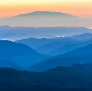 Blue mountains with sunset in the back