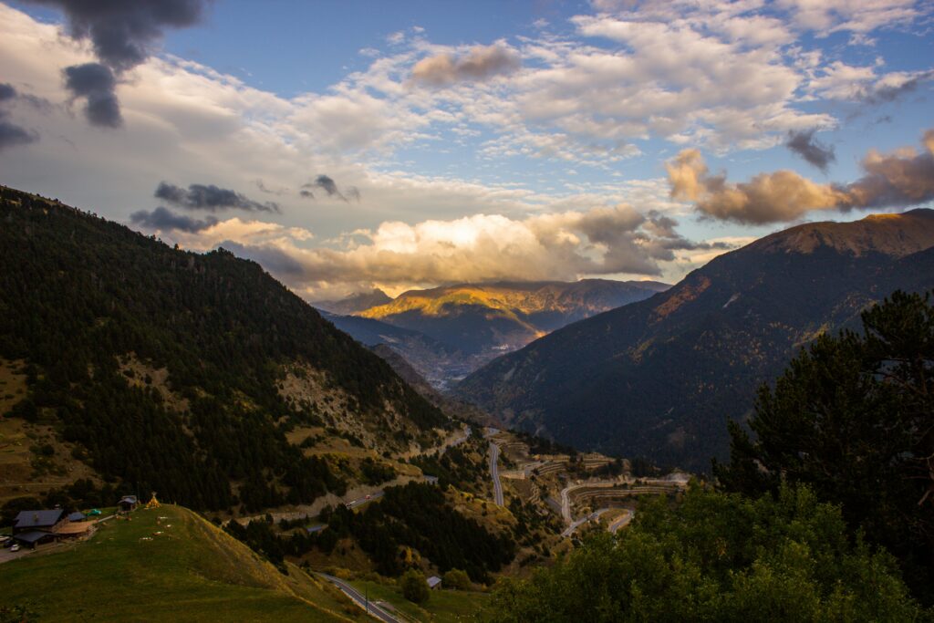 Mountain with sun behind clouds